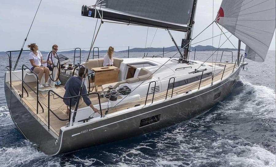 Four sailors in the cockpit of a 44 ft yacht under sail