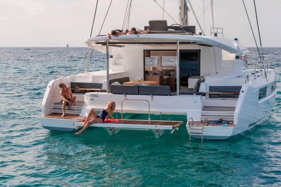 Guests on the swim platform and flybridge of a 50 ft catamaran
