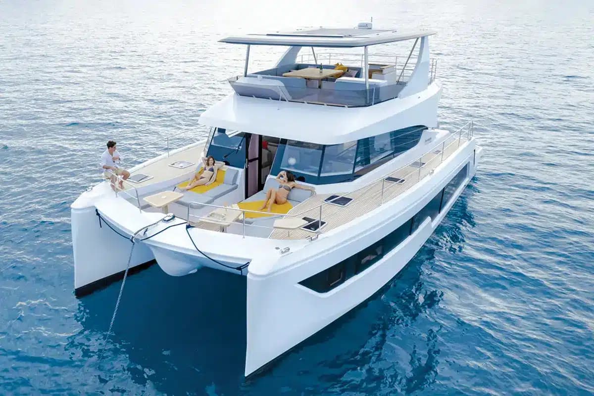 A family power catamaran with guests sunbathing on the foredeck