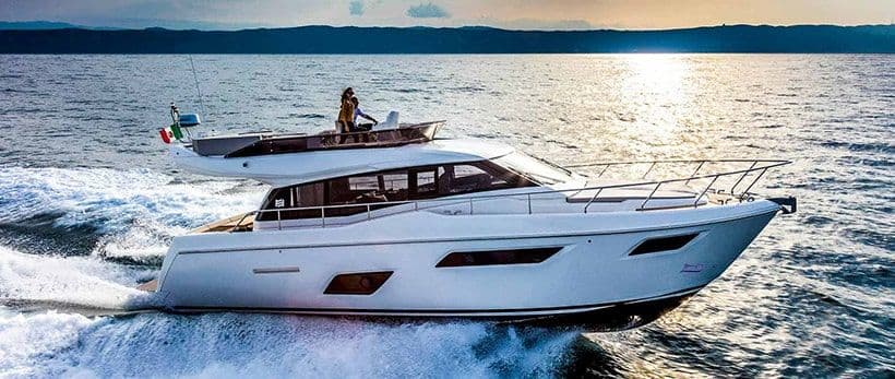 A flybridge motor yacht under way in the evening sun