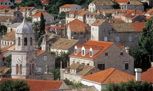 Terracotta rooftops and a stone bell tower in Cavtat, seen from above