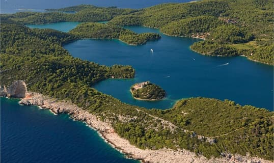 Aerial view of Mljet's wooded saltwater lakes, with the small island and its monastery in the middle of the larger lake