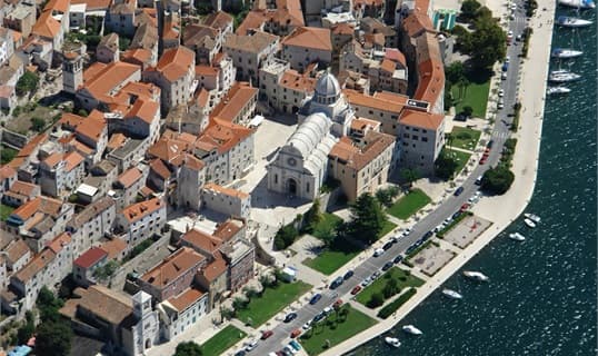 Aerial view of Šibenik's old town, the domed cathedral of St James at its centre and boats along the waterfront