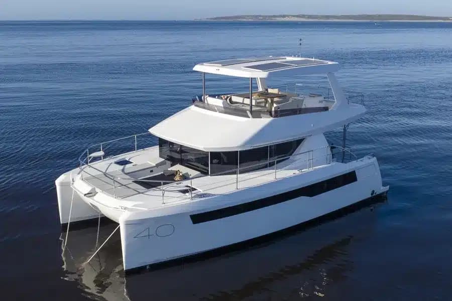 A 40 ft power catamaran under way on calm water